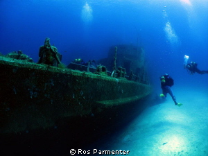 Divers approaching the wreck of the P31 off Comino Island by Ros Parmenter 